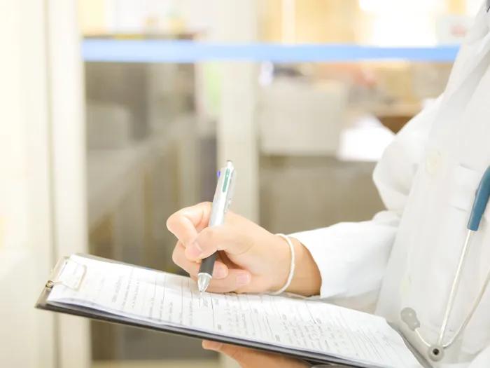 doctor writing paperwork