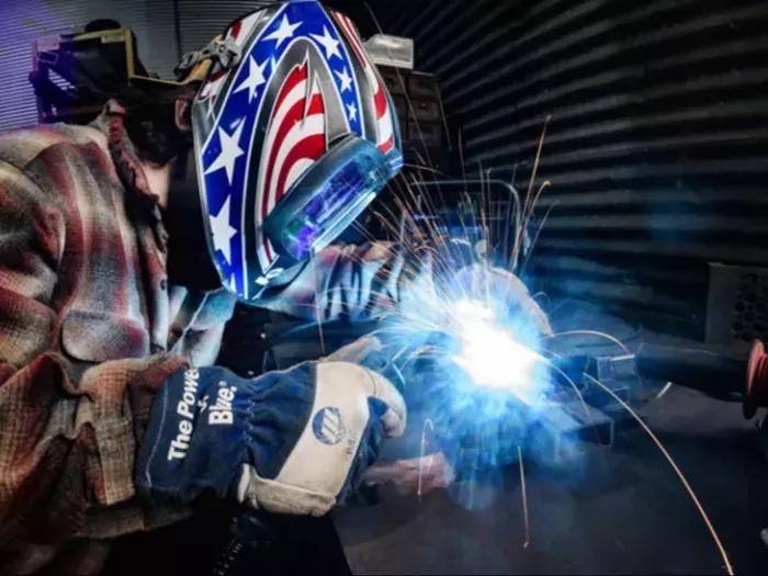 Photo of a man welding with sparks flying