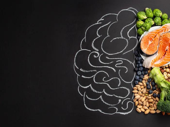 a chalk drawing of a brain with healthy food on one side 