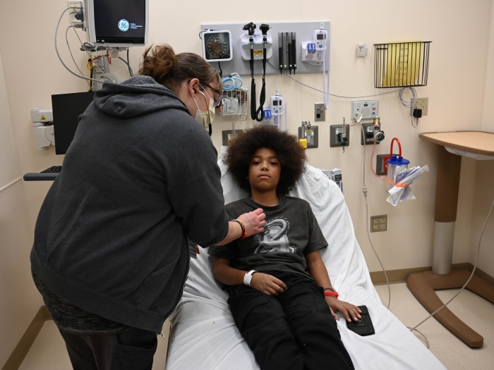 A PA listens to a patients heart
