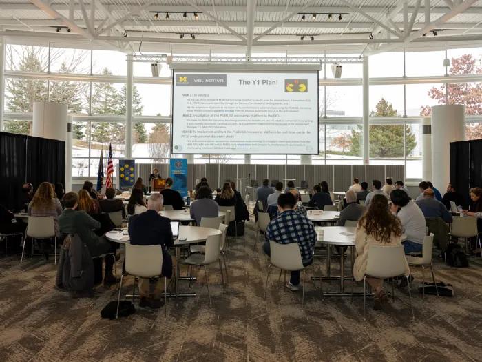Crowd shot of attendees at the 2026 Kahn Grand Challenge kickoff listening to a presentation by Dr. Heidi Flori.