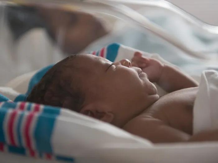 newborn close up in clear bassinet