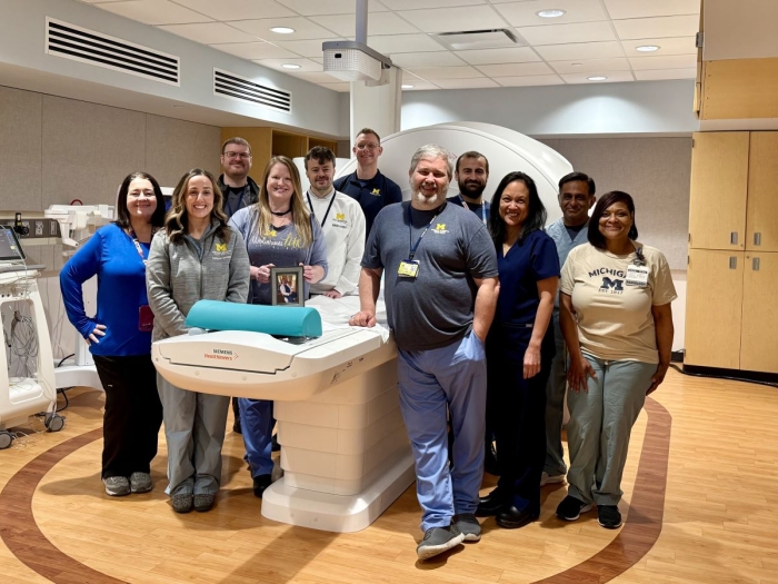 group of medical teammates huddled around the MRI machine 