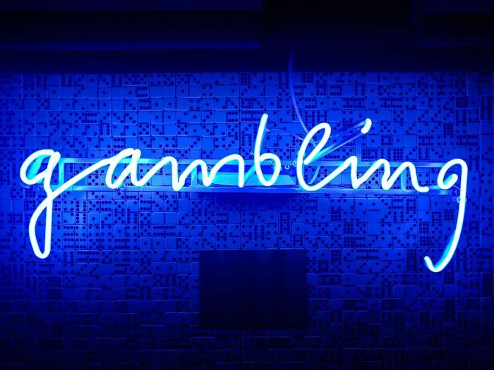 a neon sign that spells out the word "gambling"