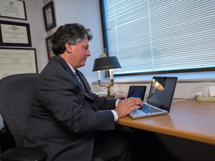 Man using a laptop in an office