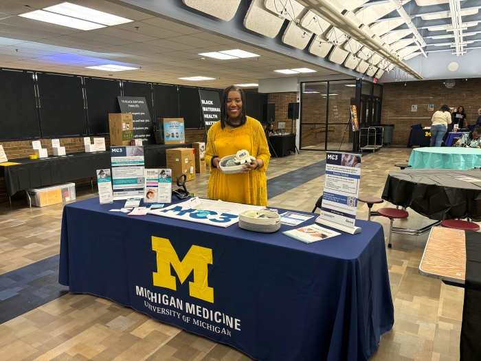 Carme Harrison working an info table