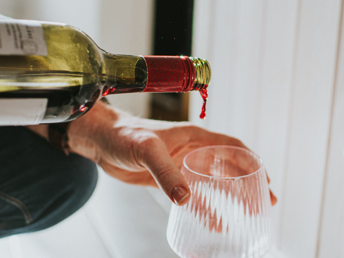 wine being poured into glass 