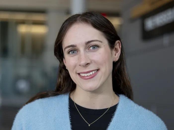 Ailish Dougerty, a woman with dark hair, wearing a light blue cardigan and black shirt