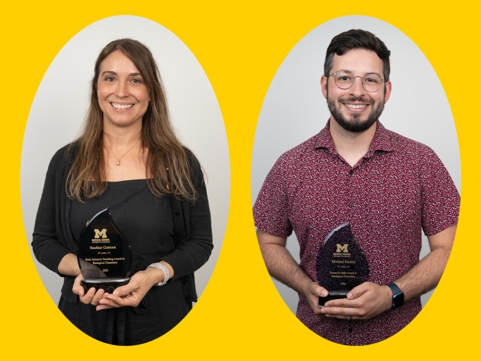 Two smiling people holding individual awards