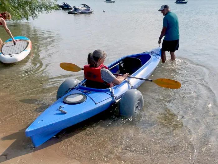 girl going in canoe with instructor in water 