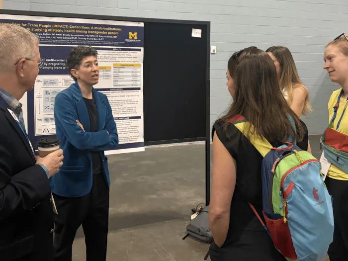 Team members discussing a research poster