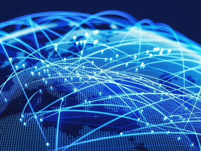 Graphic of a globe with icons depicting people and lines connecting them to each other in other countries