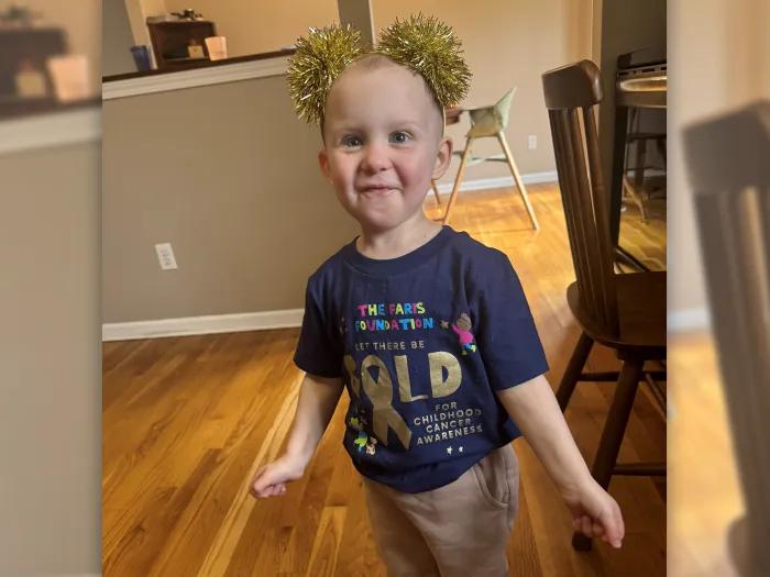 baby with sparkling head ban smiling in house