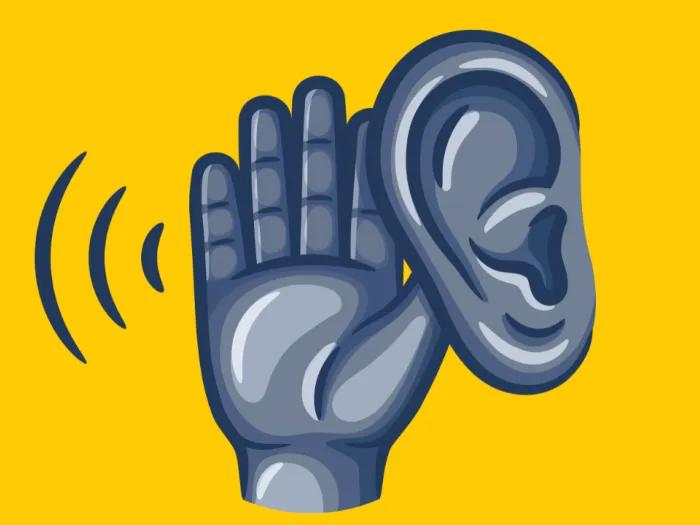 an ear with a hand nearby 