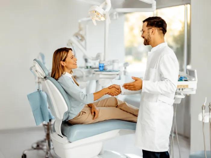 dentist and patient talking in a dental chair