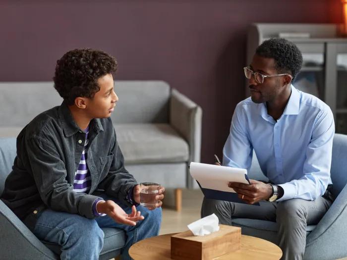 doctor and patient talking in a waiting room