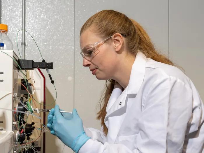 scientist injecting sample into HPLC