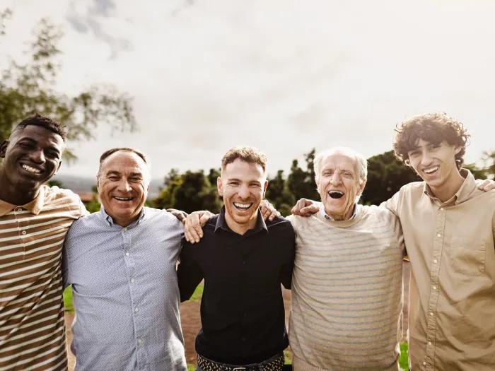 Group of men smiling in a field