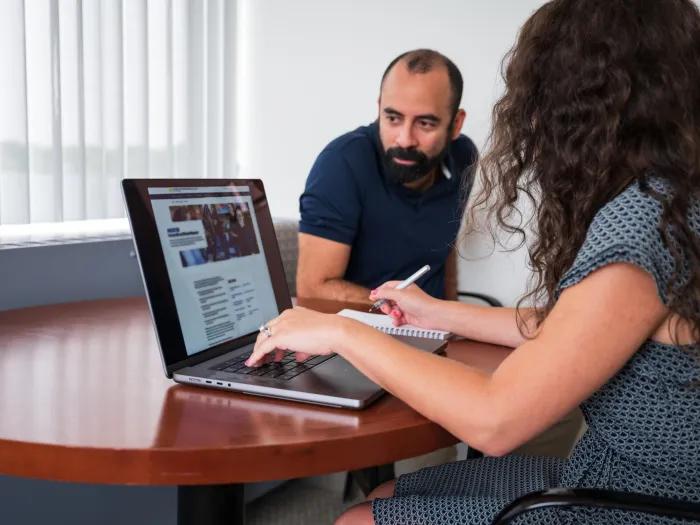 Photo of two people (man and woman) at a computer