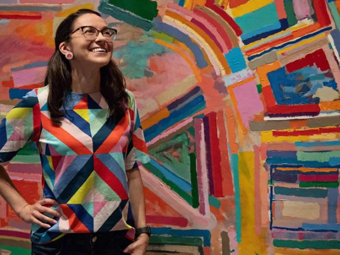 Woman in front of painting 
