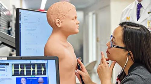 U-M Medical School team member working on a PAT exam in the Clinical Simulation Center