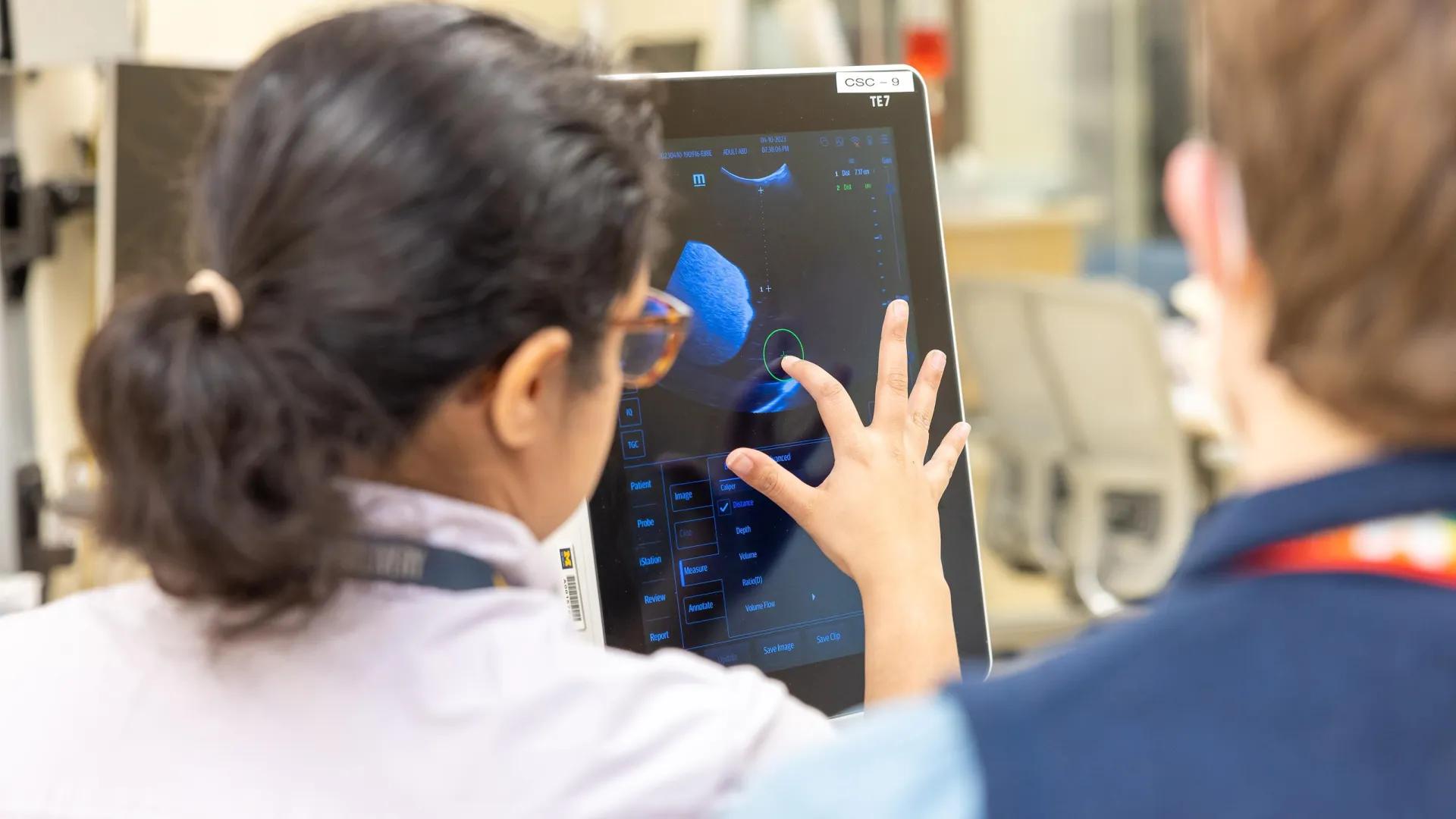  resident points to lab scans on a screen