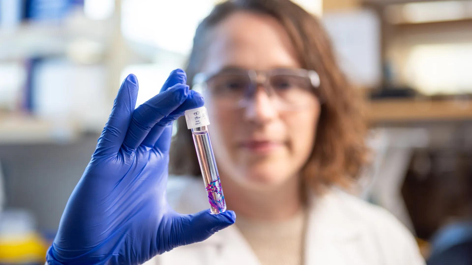 a person holding a test tube