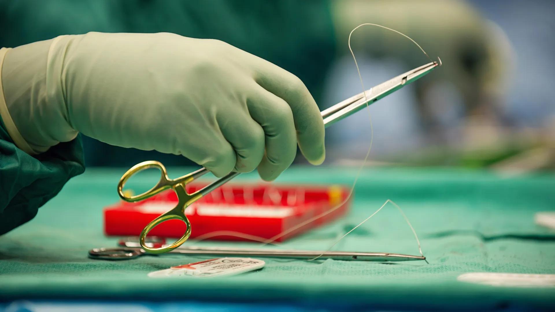 A person holding a pair of scissors.