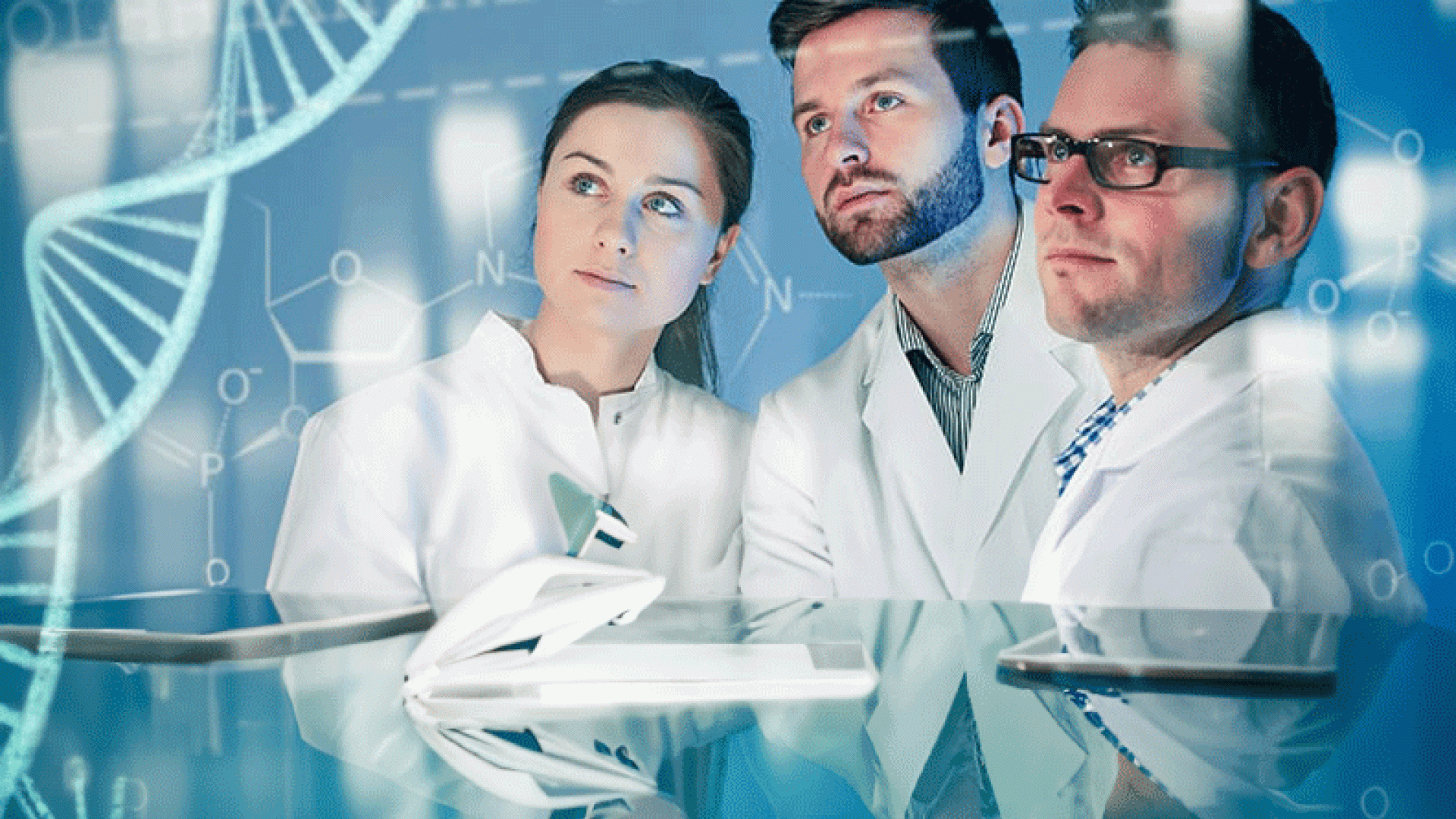 Three scientists gazing at a DNA model