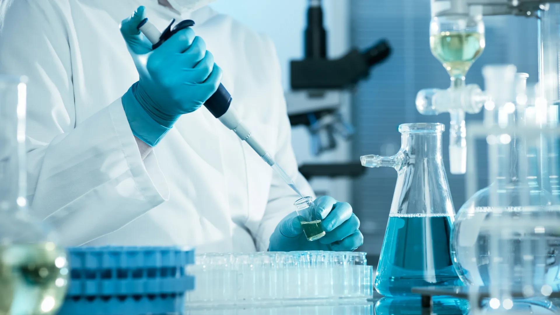 Researcher hand with blue gloves handling some samples in a lab