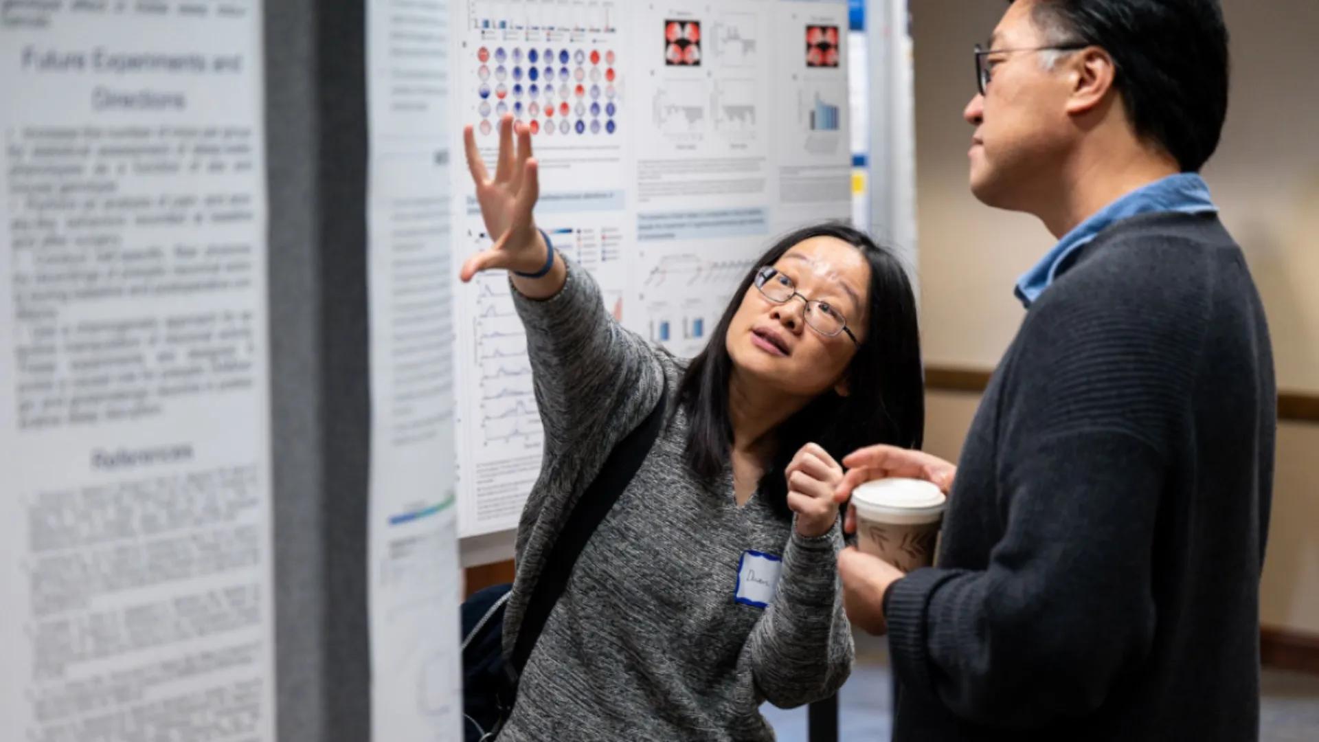 man and woman at poster presentation