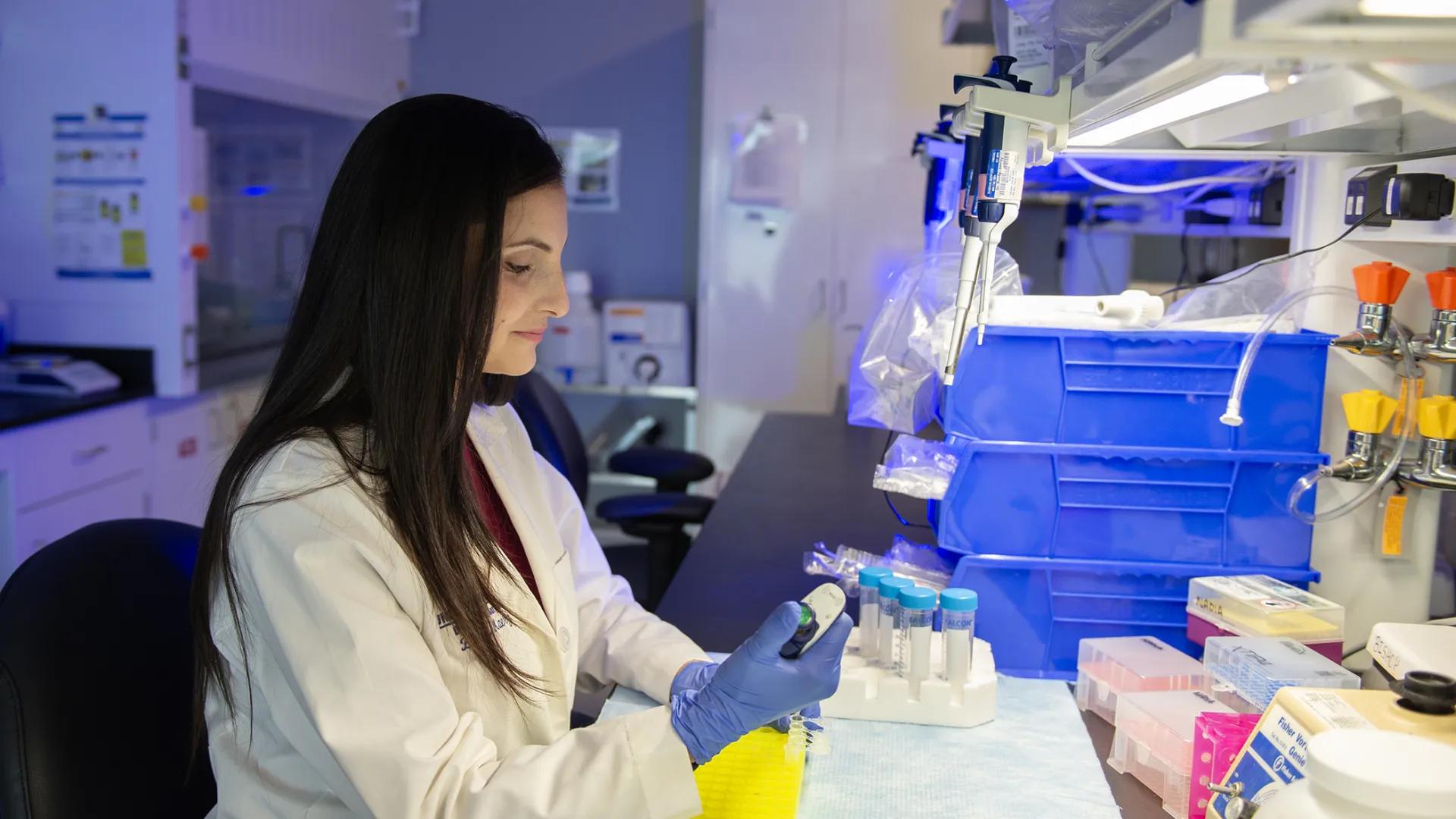 Lab member working with equipment in the lab