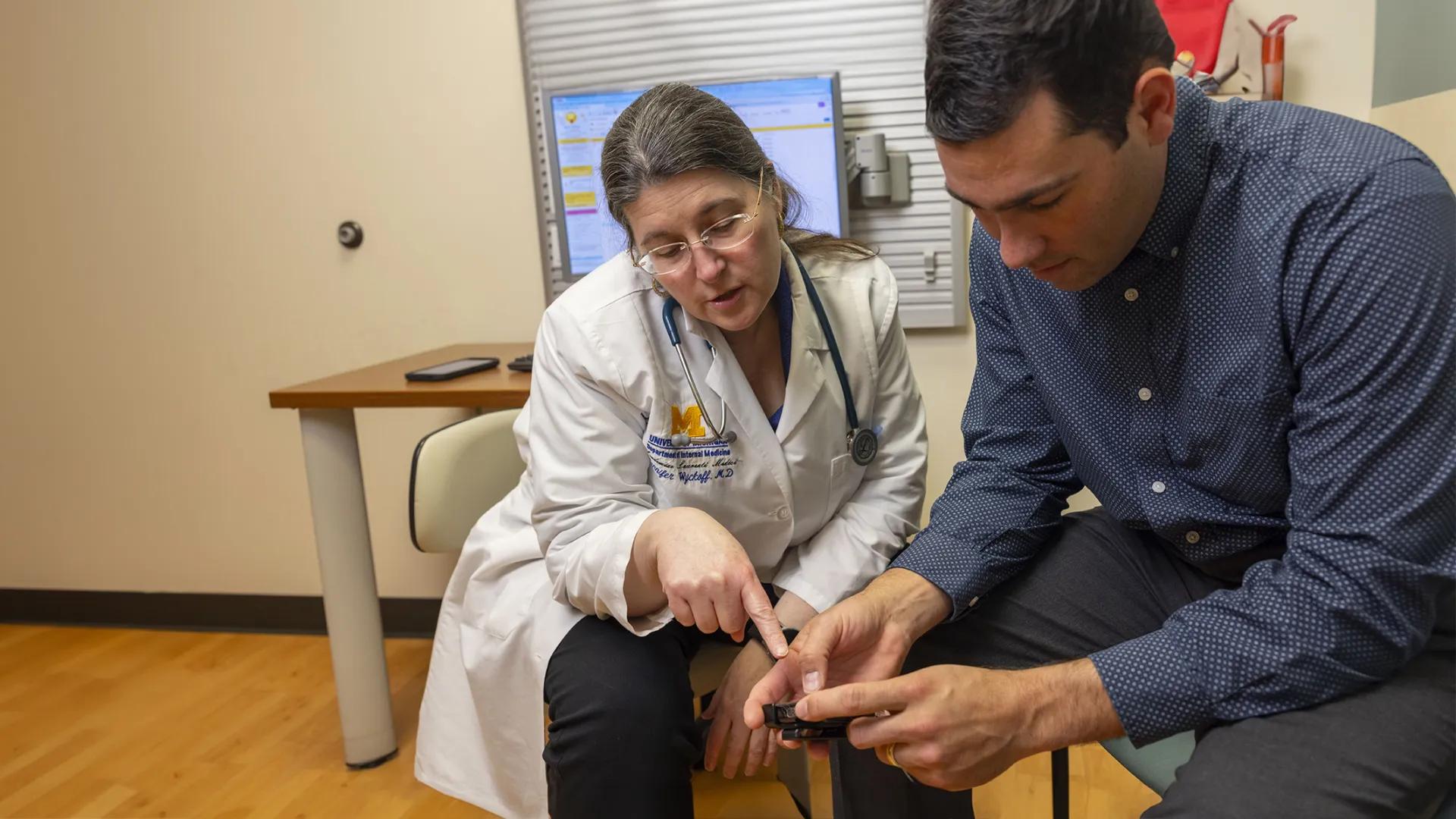 doctor and patient looking at medical equipment