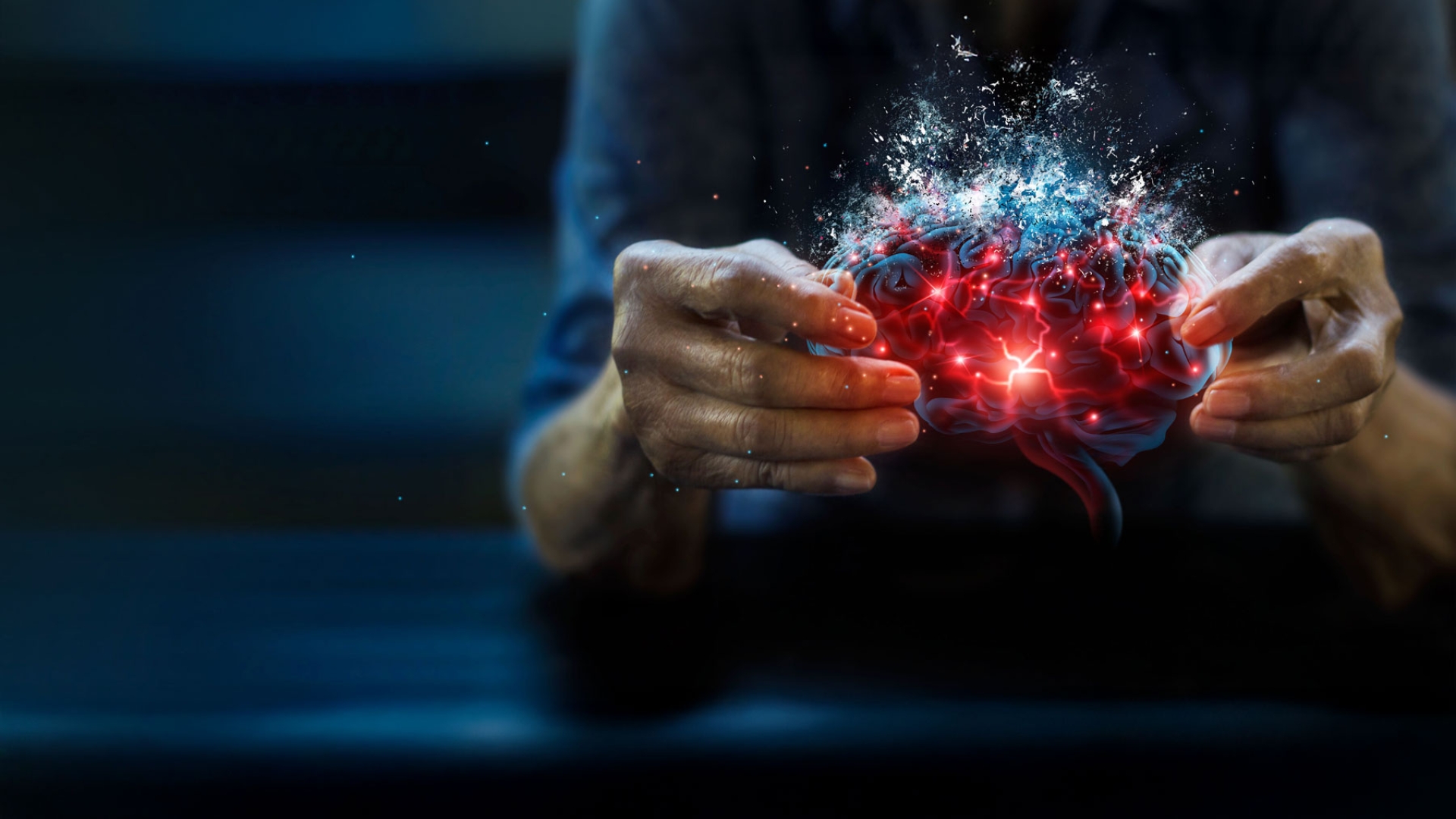 Woman's hands holding brain with bright red synapses displayed