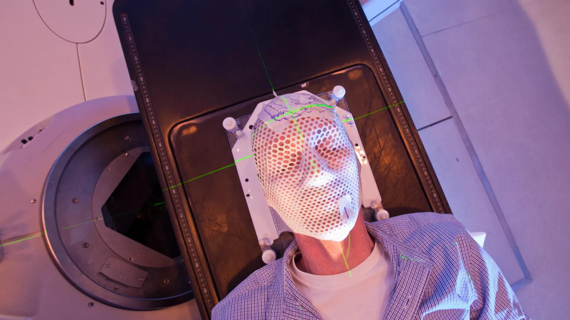 Patient lying under a linear accelerator or linac for cancer radiation therapy