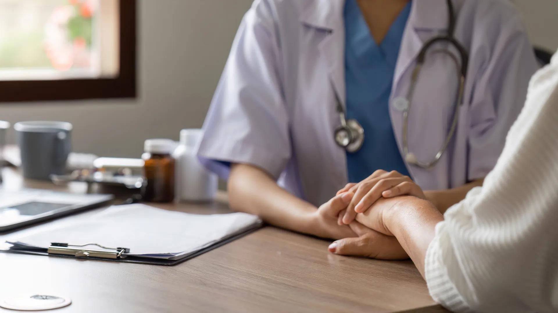 A doctor touching a person's hand