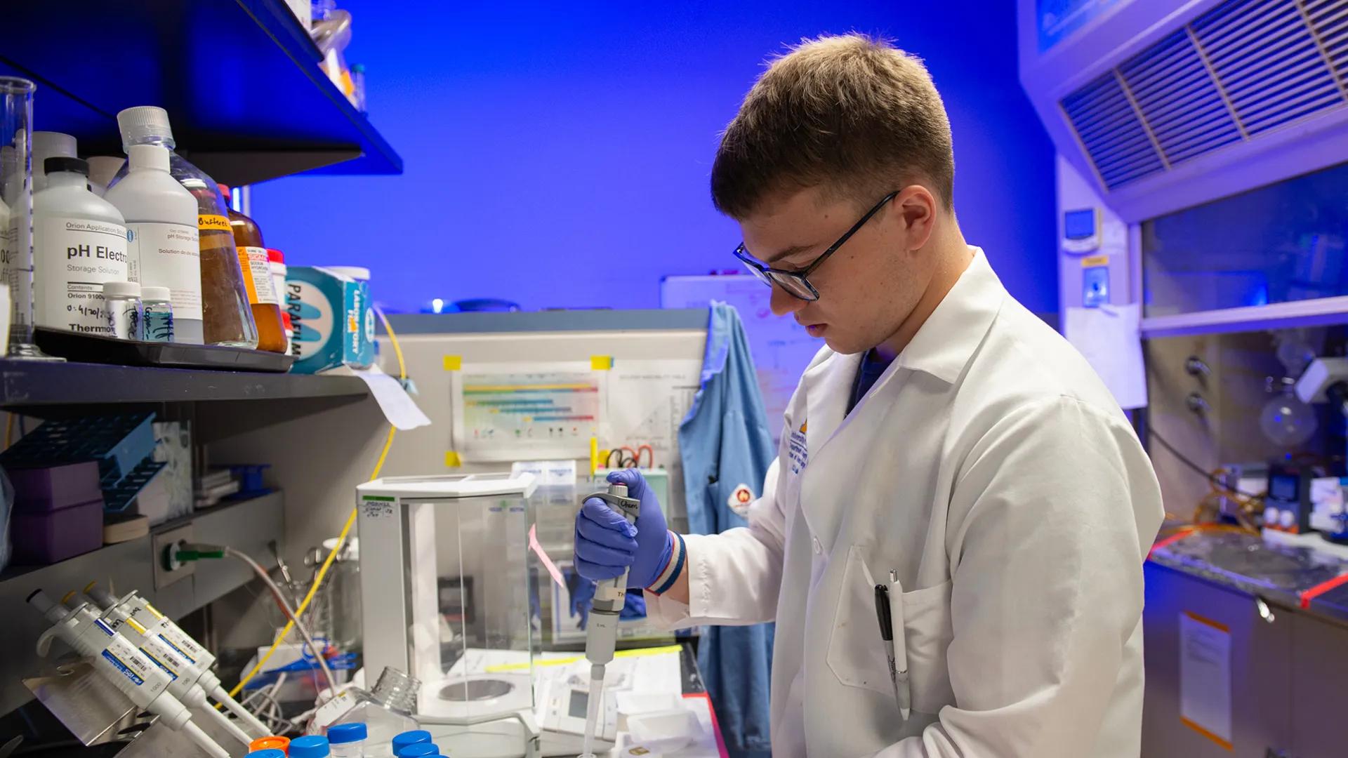 Lab member working with equipment in the lab