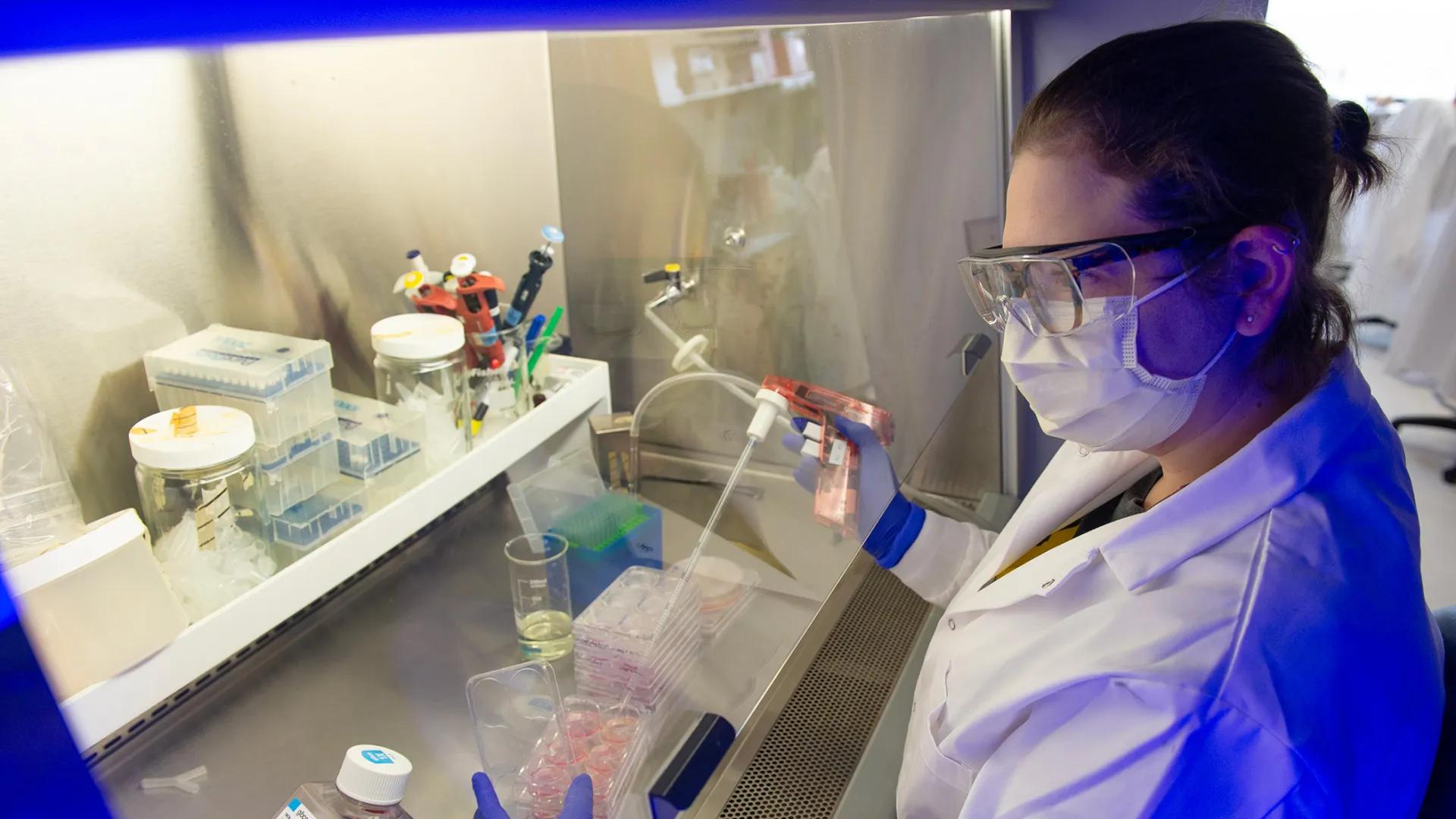 Lab member working with equipment in the lab