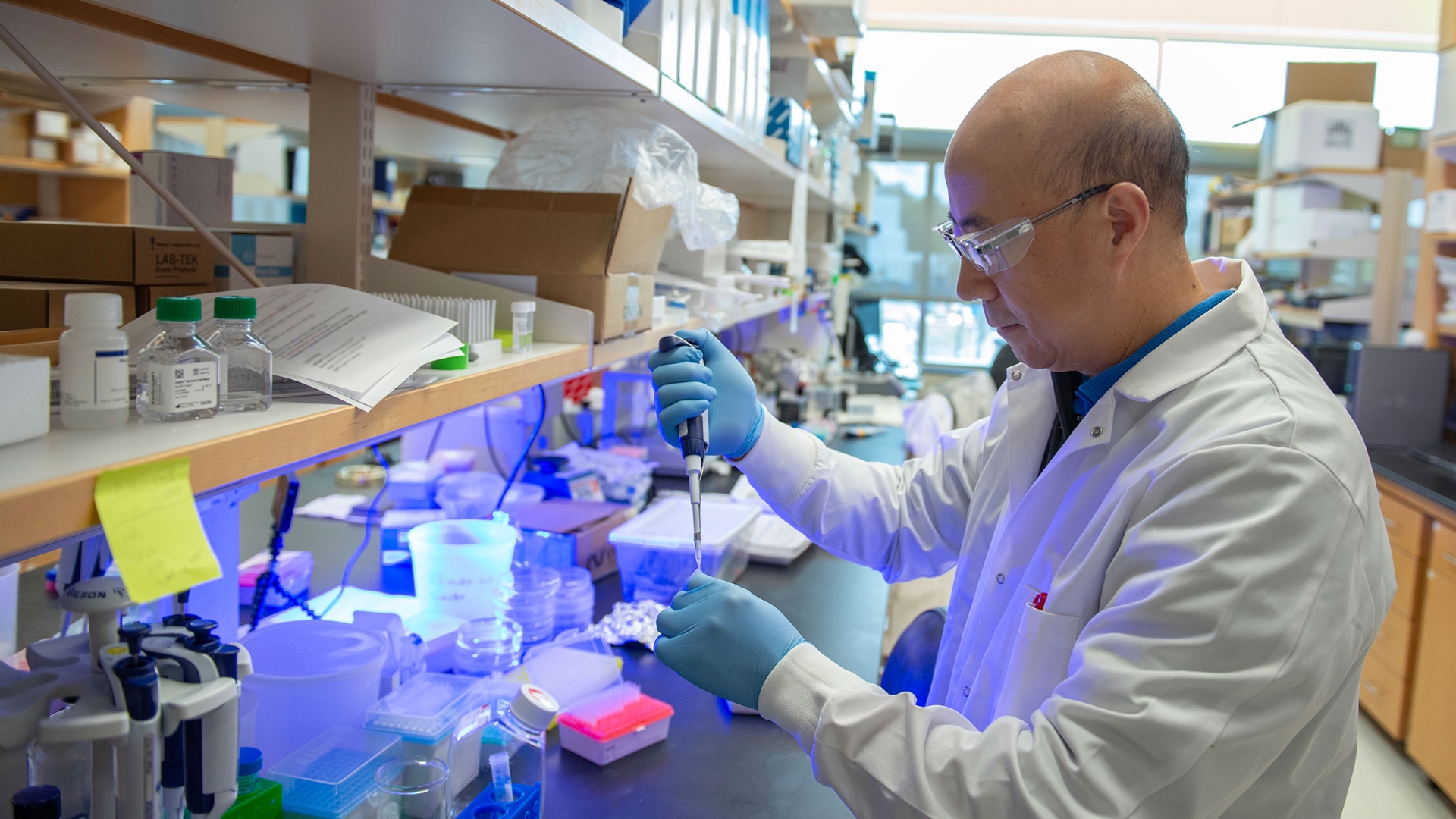 Lab member working with equipment in the lab