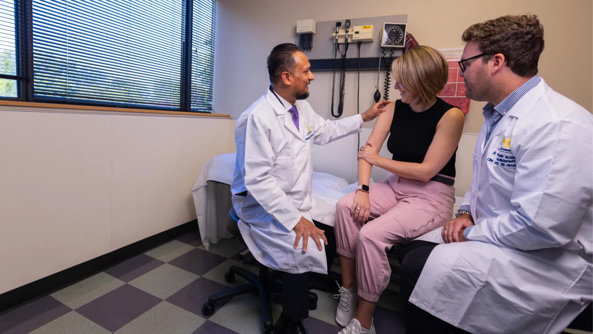 PMR Chair and Resident with patient receiving shoulder exam