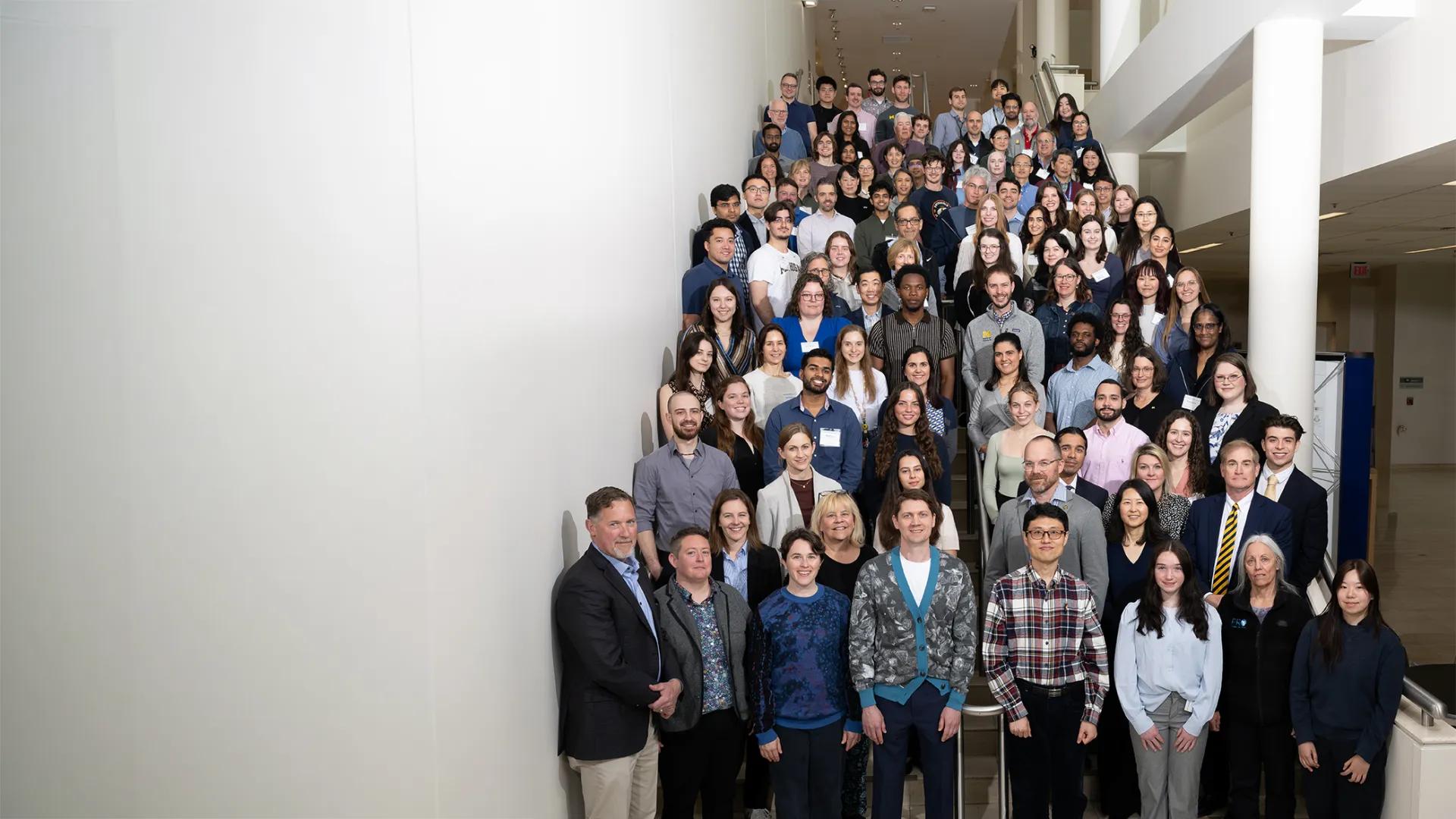 large group of people posing for a photo on a tall staircase