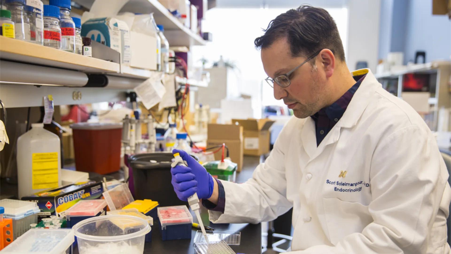 Soleimanpour at lab examining a test