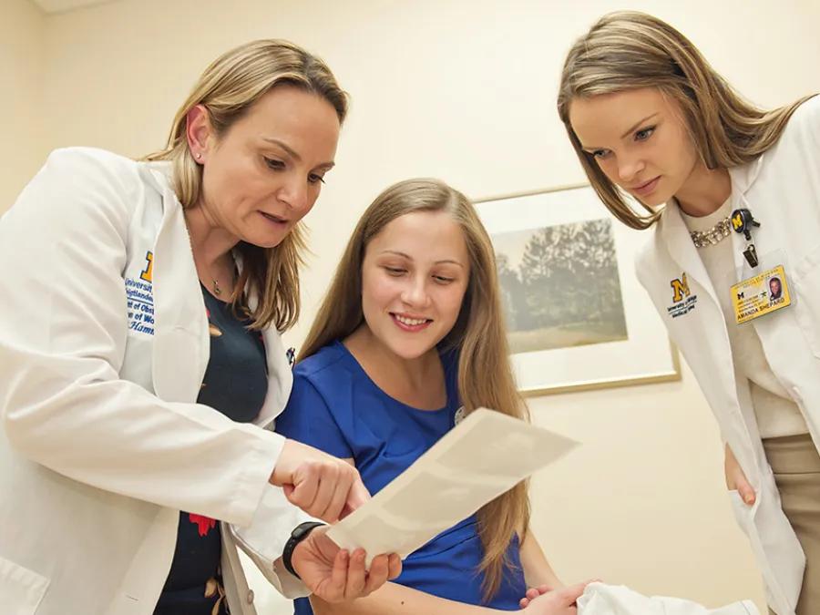 Doctor and medical student with patient