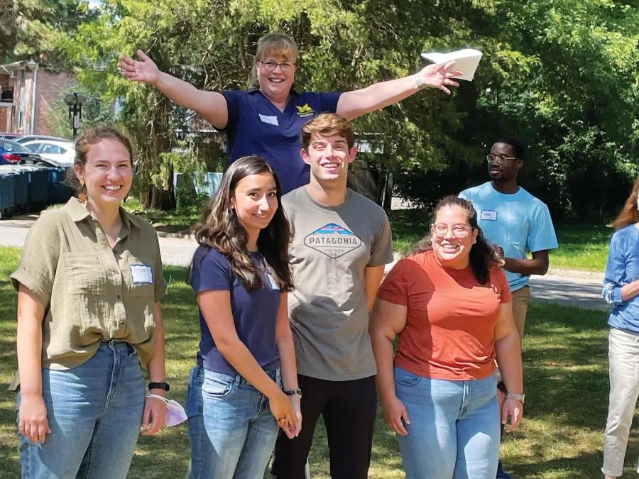 Students smiling outside at September 2023 picnic