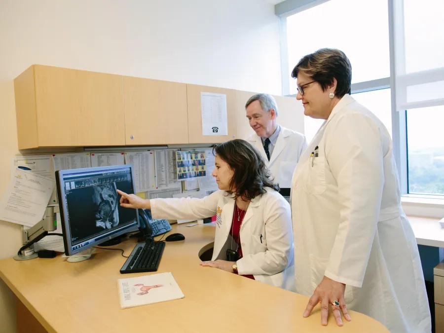 doctors reading scans on computer in office 