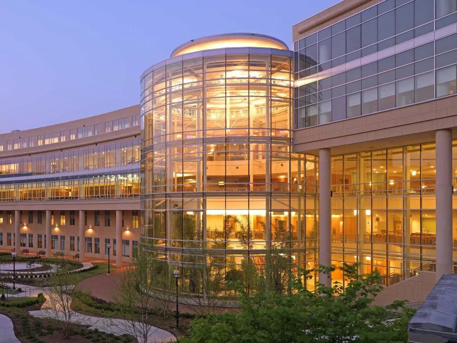 exterior view of cardiovascular center at dusk with views of spiral garden and interior atrium 