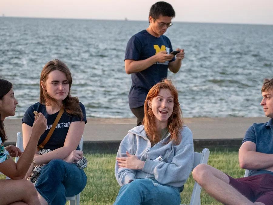 DCMB students sitting by the lake during annual picnic.