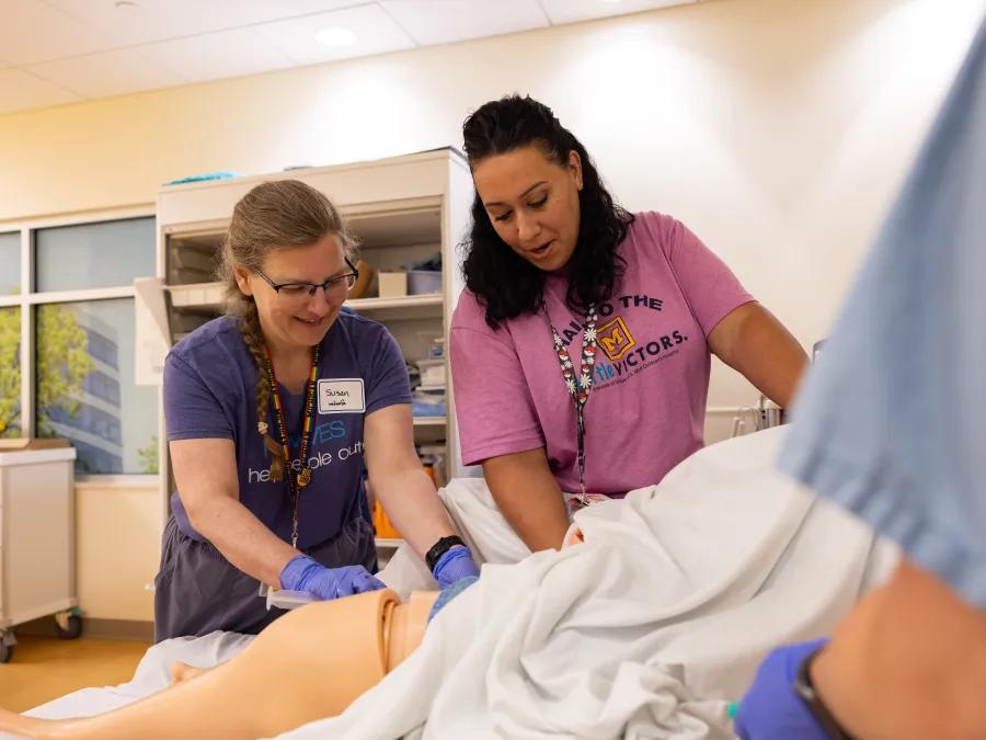 Doctor and resident lean how to care for patient in simulation 