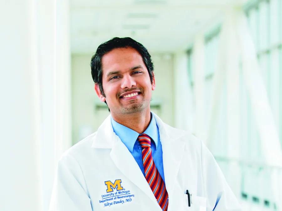 a person in a white coat smiling