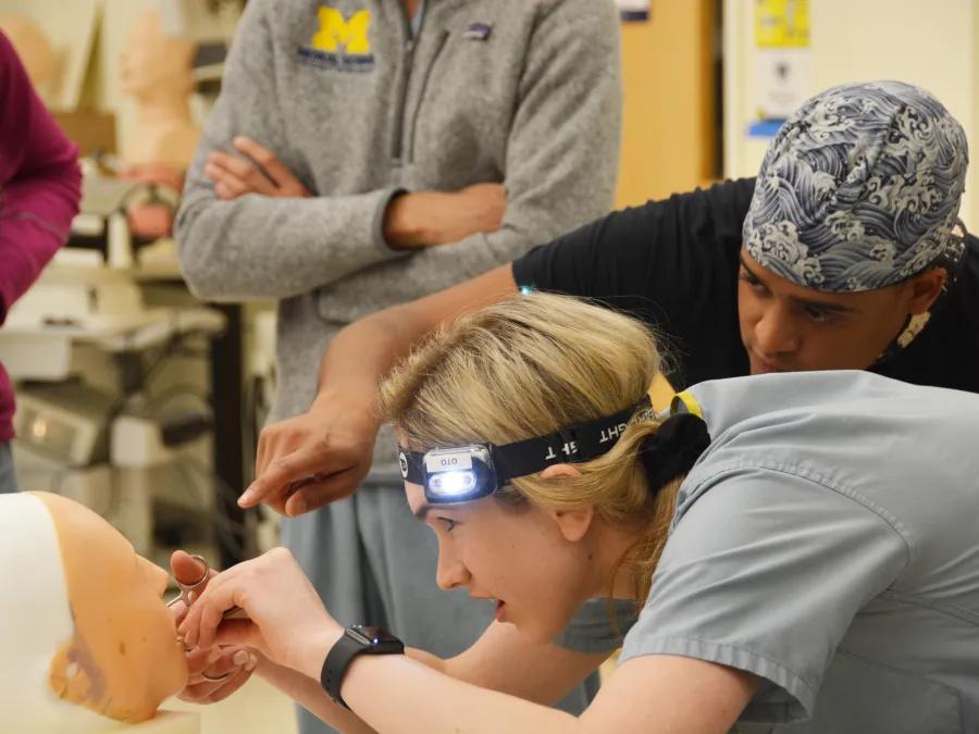 too student wears headlamp while training in a simulation 